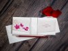    Esküvői meghívó - 230x90 mm - 3 részre nyitható - gyöngyházfényű bordázott krém karton, színes mintával, formakivágással - aranyozott papírszalaggal átköthető - boríték: krém
