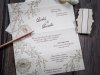    Esküvői meghívó - 230x90 mm - 3 részre hajtható krémszínű gyöngyházfényű karton - belül barna nyomott minta - összehajtás után aranyozással-bársonyozással díszített papírszalaggal átköthető - boríték: krém